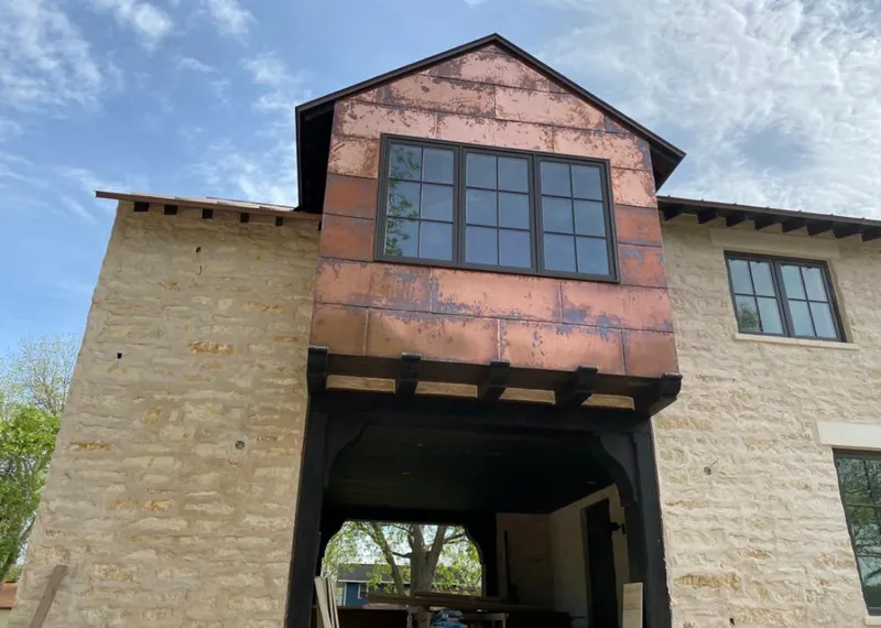 Copper metal panel facade on a stone building for Skylight Installation in Tremonton